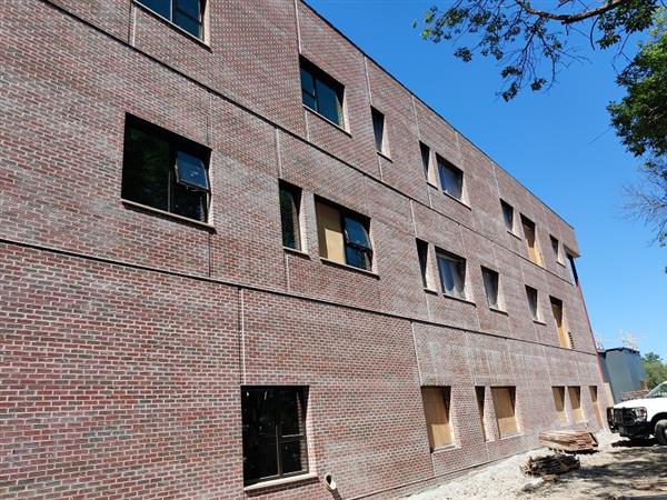 Brick is completed on the south side of the new three-story addition